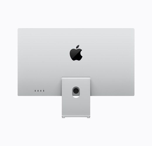 Apple Studio Display i sølv, vist bakfra, med justerbart stativ og en blank svart Apple-logo i midten.