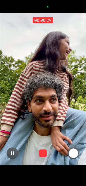iPhone 17 screen demonstrating stabilised video recording as man carries young girl on his shoulders