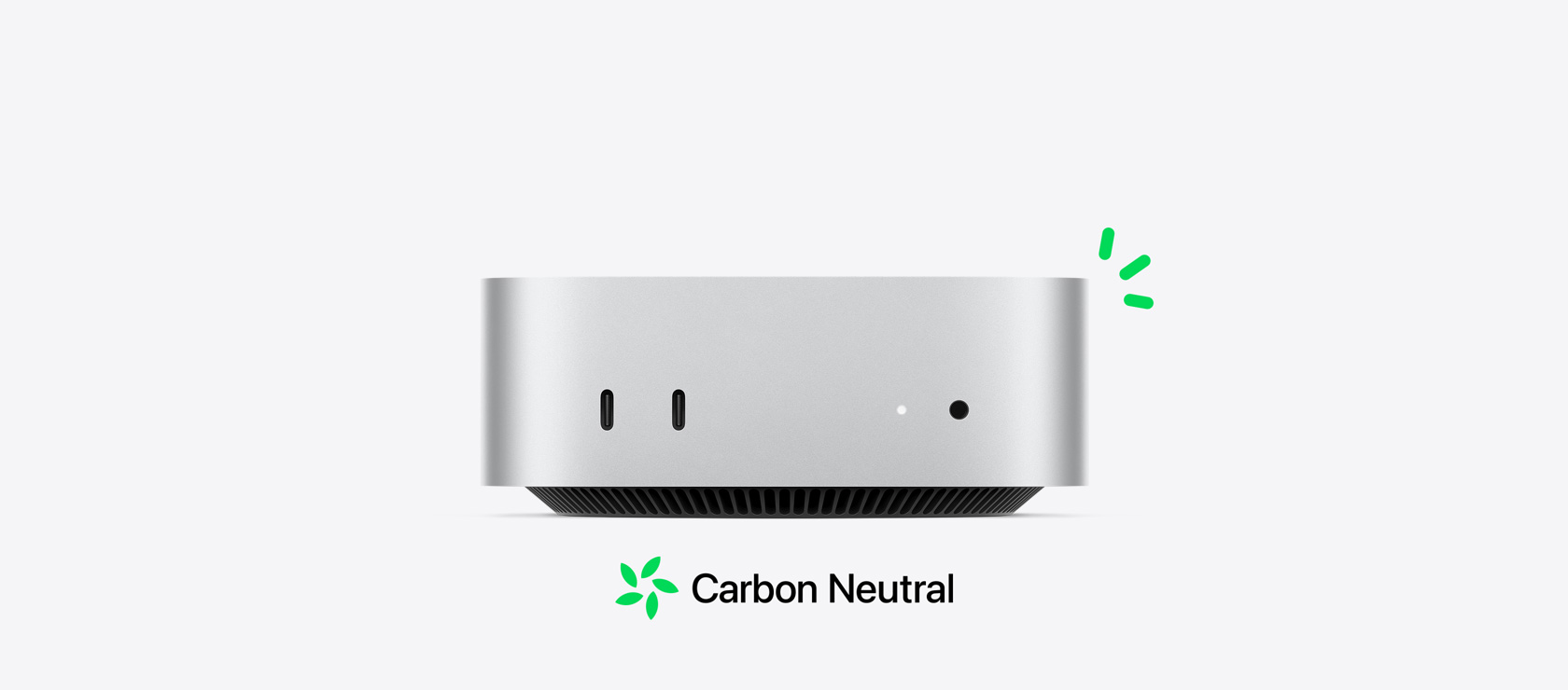 Vooraanzicht van een zilverkleurige Mac mini met de poorten aan de voorkant. De tekst over CO₂-neutraliteit wordt geïllustreerd met kleine groene accenten.