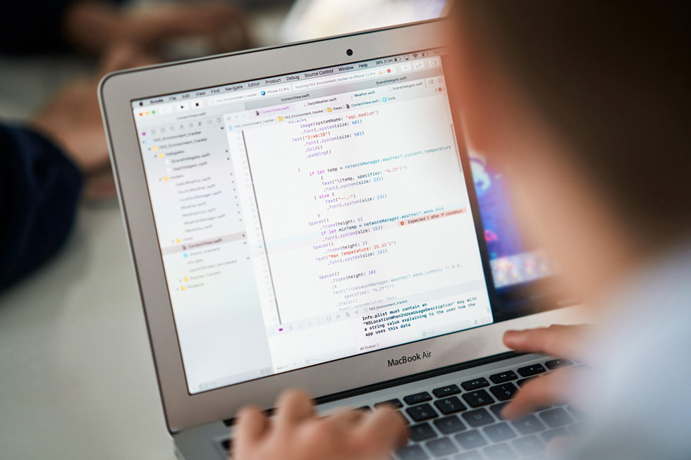 A student reviews code on MacBook Air.