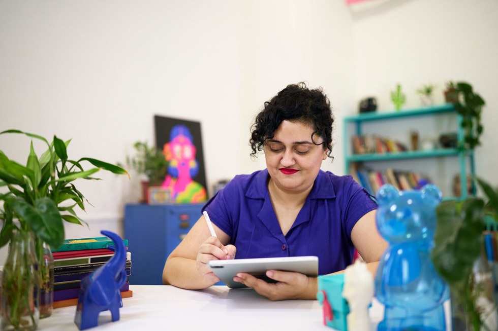 Mira Felicia Malhotra using iPad Pro at her desk.